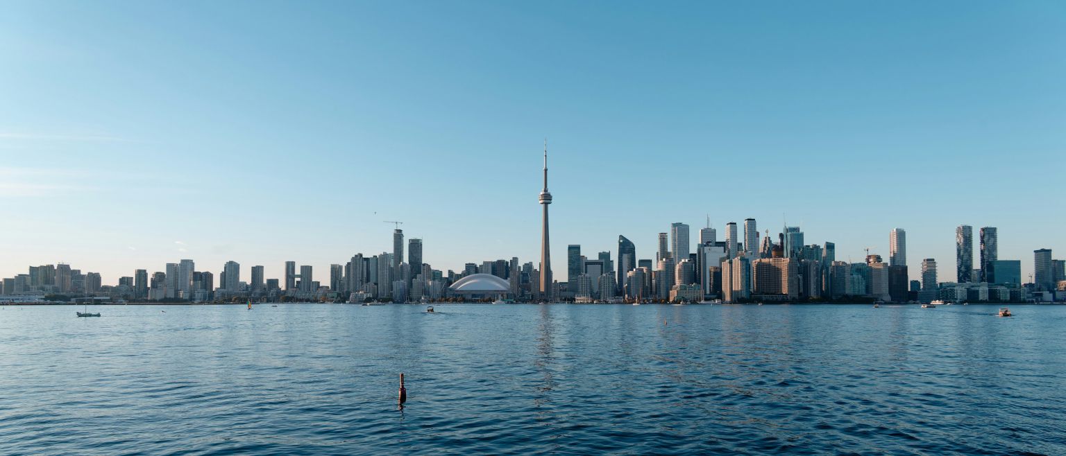 Toronto skyline and CN Tower viewed across Lake Ontario in daylight